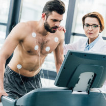 Patient undergoing cardiac stress test on treadmill