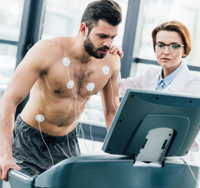 Patient undergoing cardiac stress test on treadmill