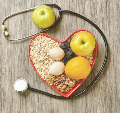 Heart-shaped bowl of healthy food with stethoscope