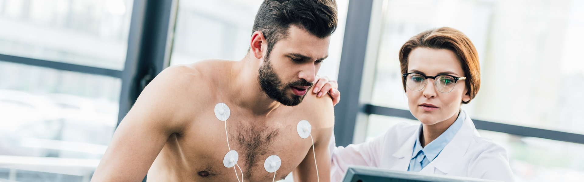 Patient undergoing cardiac stress test on treadmill
