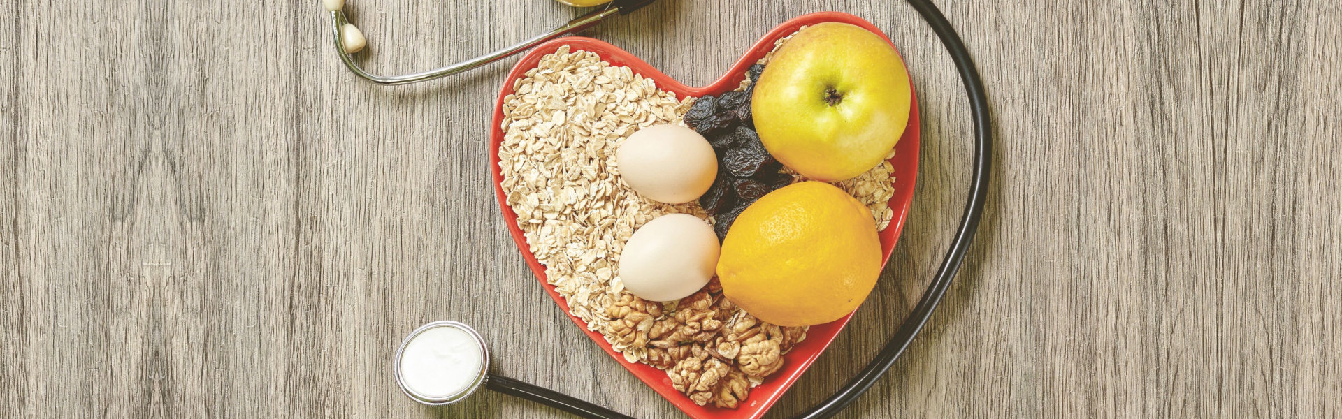 Heart-shaped bowl of healthy food with stethoscope