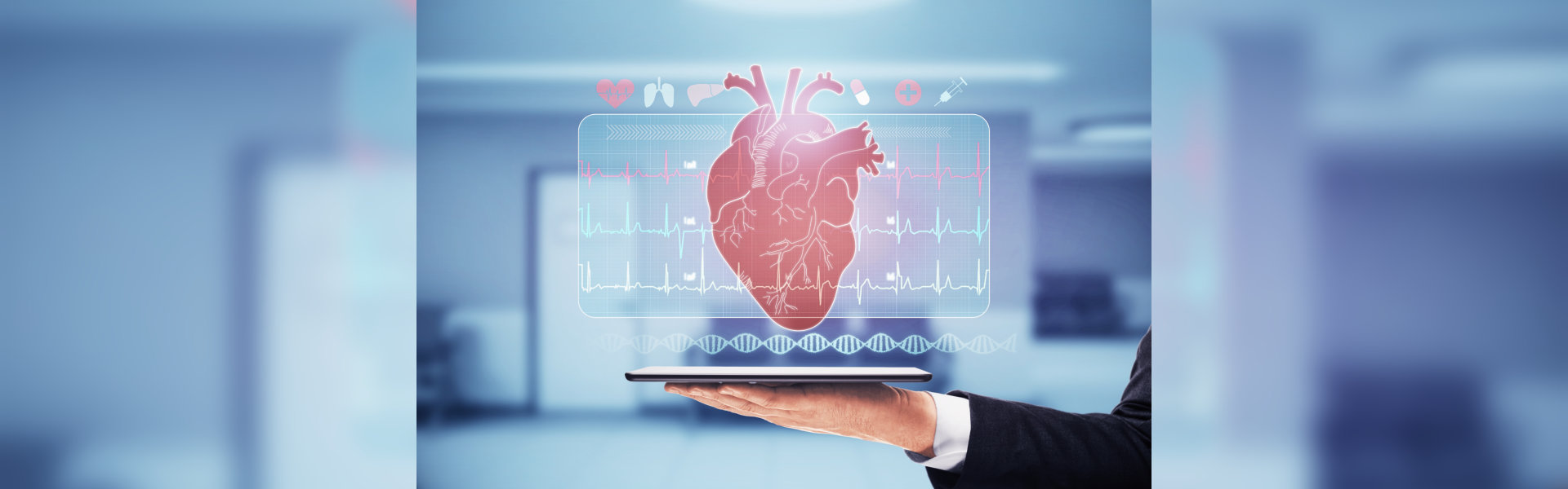 An adult holds a tablet displaying a digital heart illustration