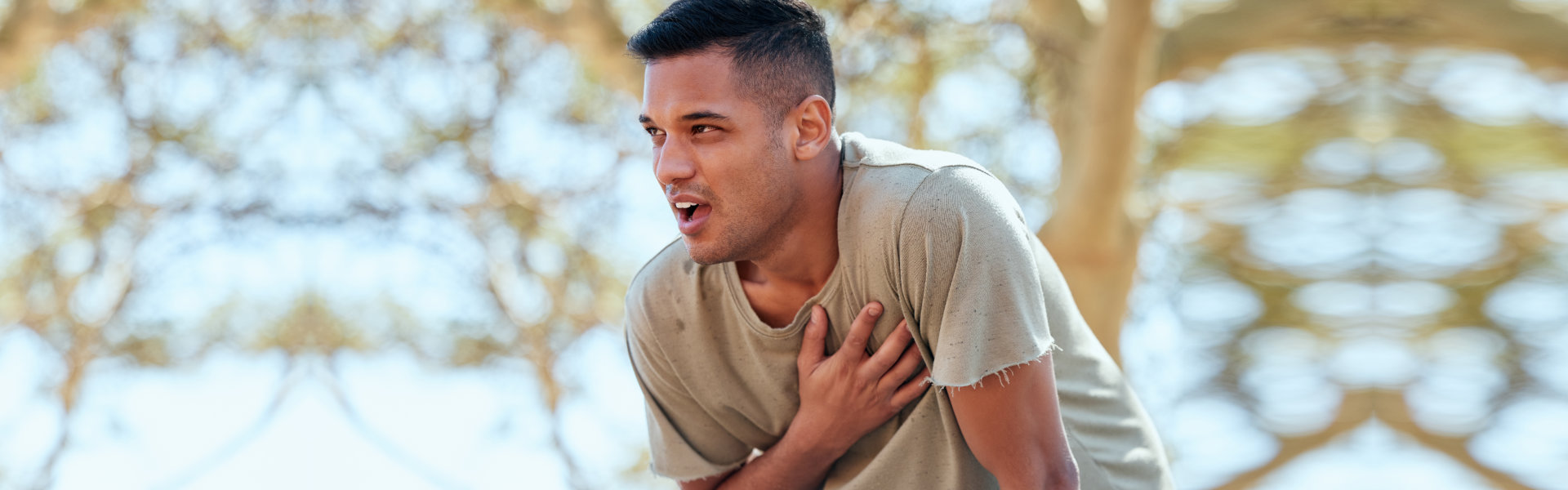 young man holds his hand to his chest